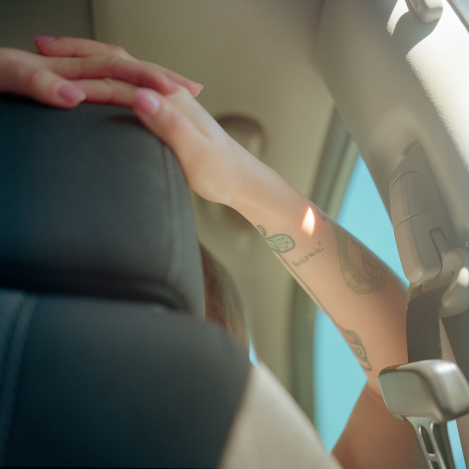 An arm resting inside a car