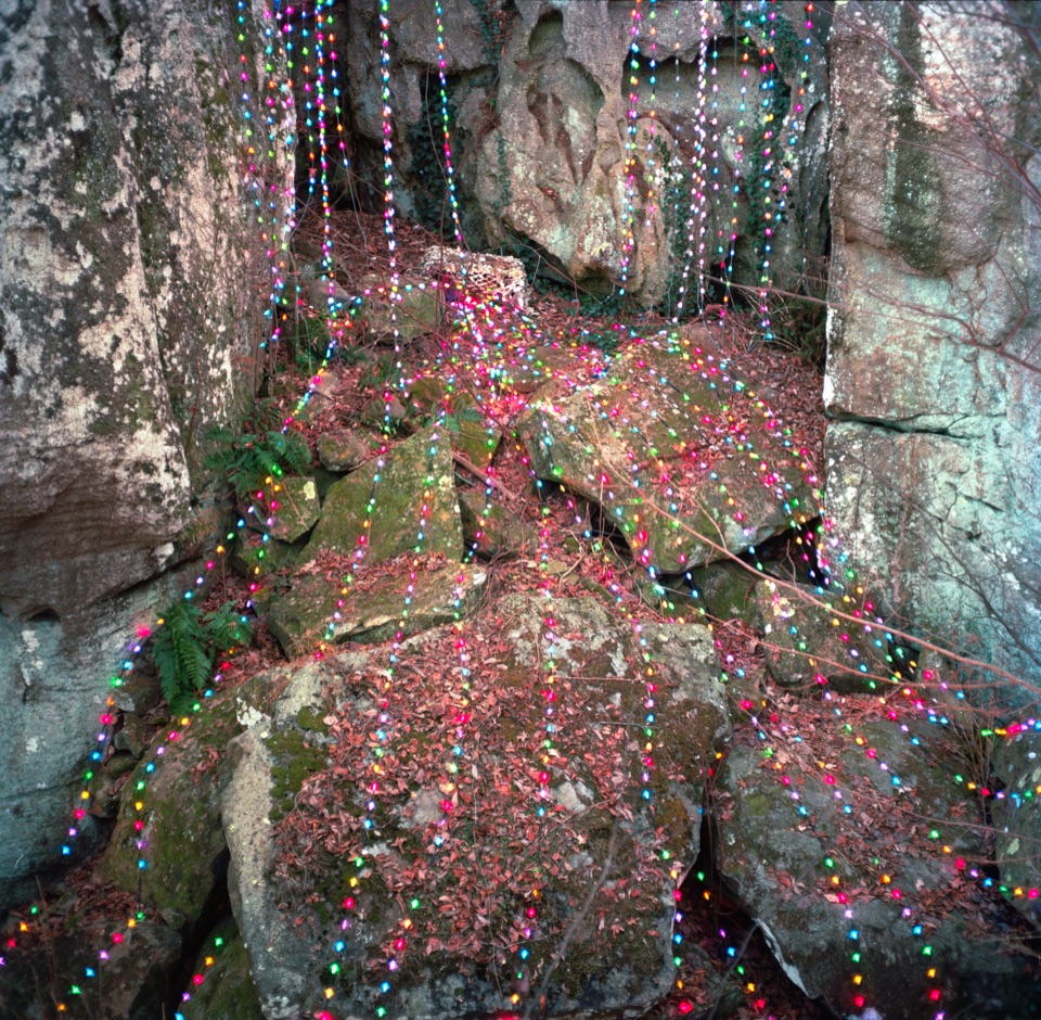 Christmas lights strung over boulders