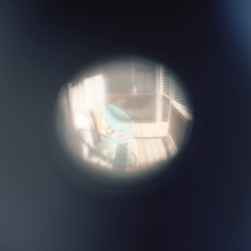 A room seen through a door peephole