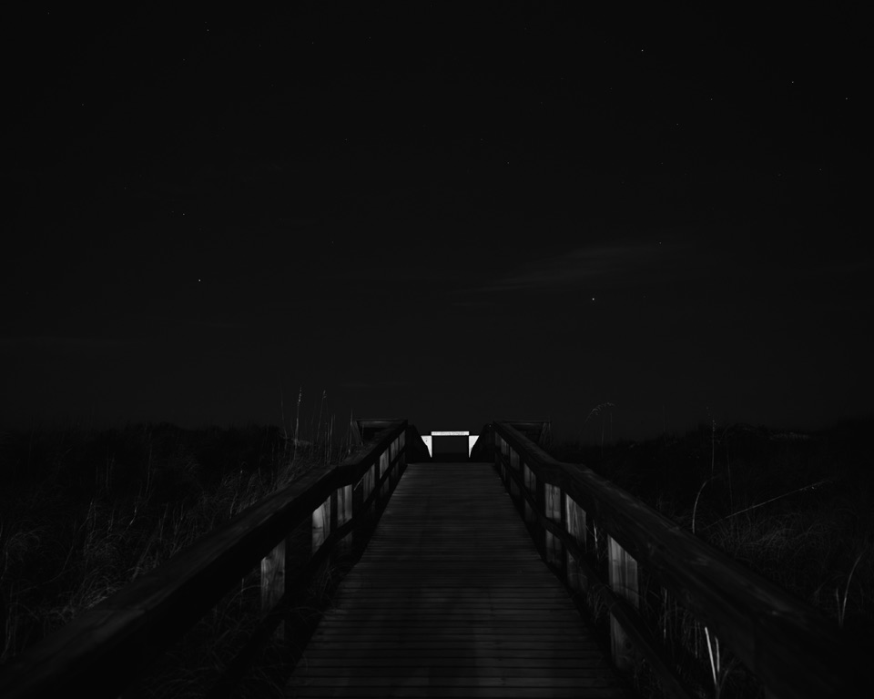 A boardwalk at night